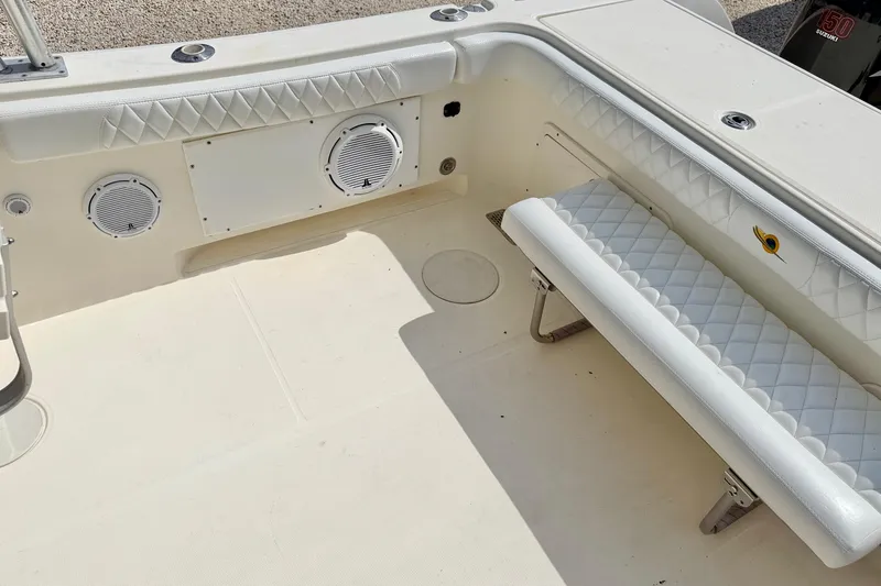 Slide: The Image of 2007 World Cat 250 DC boat interior with white quilted seating and built-in speakers. - 25