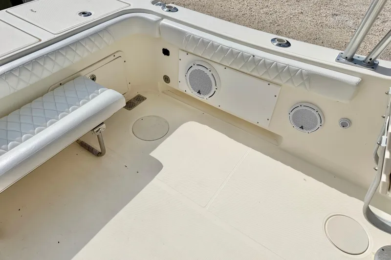 Slide: The Image of 2007 World Cat 250 DC boat interior with white seating and built-in speakers. - 26