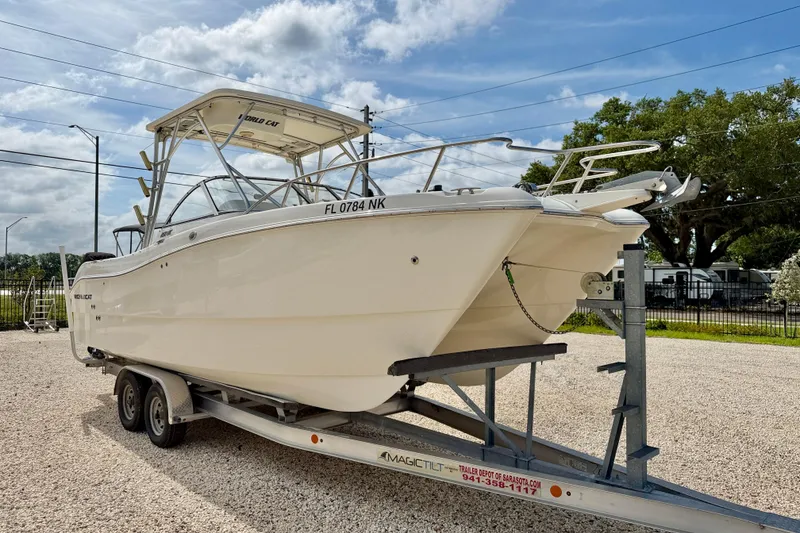 Slide: The Image of 2007 World Cat 250 DC boat on trailer, parked outdoors under a cloudy sky. - 3