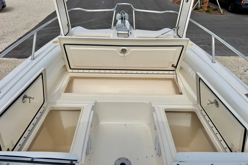 Slide: The Image of 2007 World Cat 250 DC boat with open storage compartments on deck. - 30