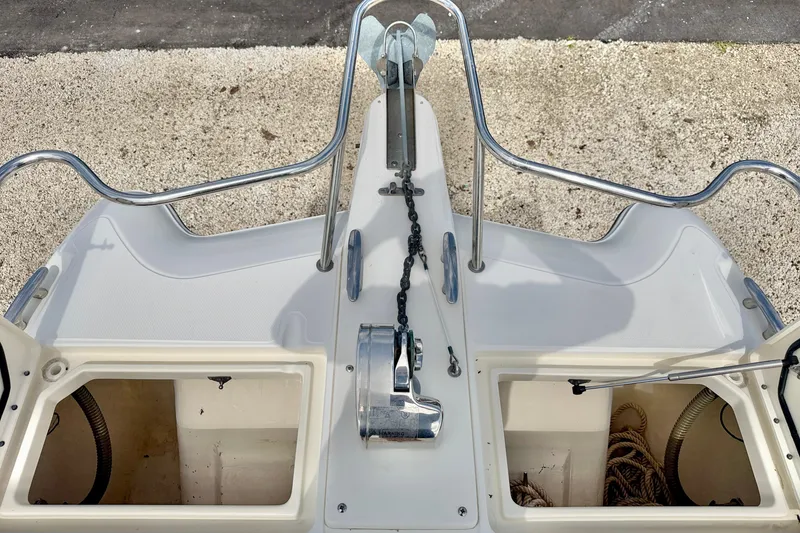 Slide: The Image of Bow view of 2007 World Cat 250 DC boat with anchor chain and storage compartments. - 34