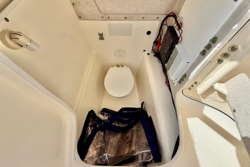 Slide: The Image of Interior of a 2007 World Cat 250 DC boat showing a compact marine toilet. - 36