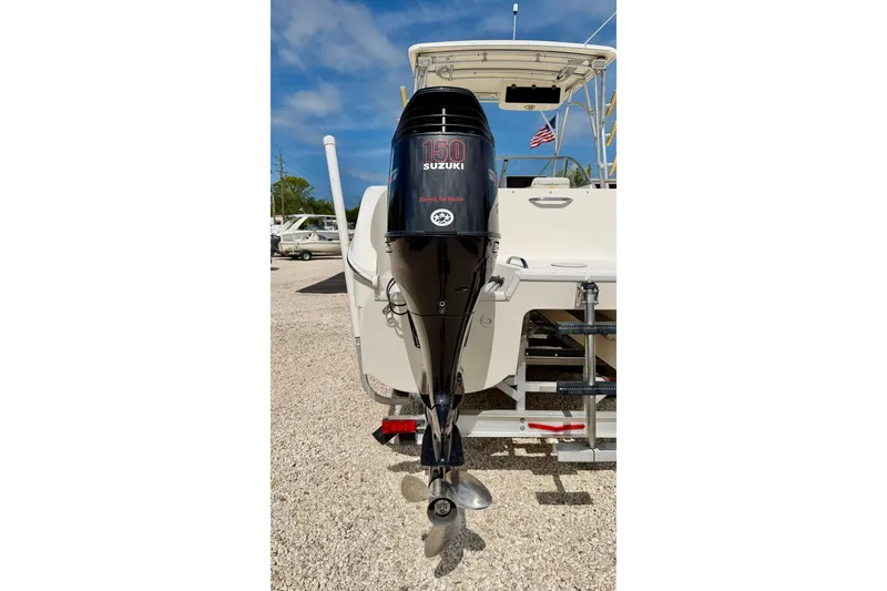 Slide: The Image of 2007 World Cat 250 DC boat with Suzuki 150 outboard motor, parked on gravel. - 41