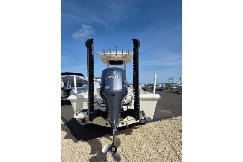 Slide: The Image of 2023 Bulls Bay 2400 boat with powerful 250 engine, displayed outdoors under clear blue sky. - 3