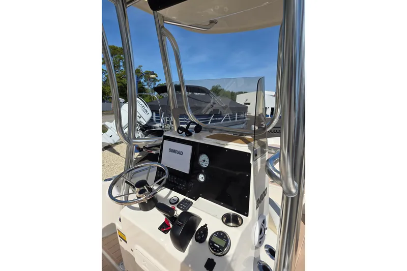 Slide: The Image of 2023 Bulls Bay 2400 boat console with steering wheel and Simrad display. - 4