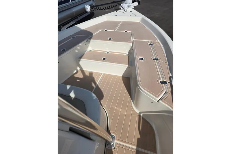 Slide: The Image of 2023 Bulls Bay 2400 boat deck with tan non-slip surface and storage compartments. - 5