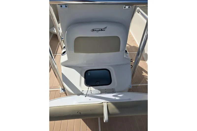 Slide: The Image of 2023 Bulls Bay 2400 boat interior with seating and storage compartment. - 7