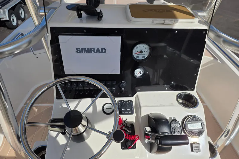 Slide: The Image of 2023 Bulls Bay 2400 boat console with Simrad display and steering wheel. - 9