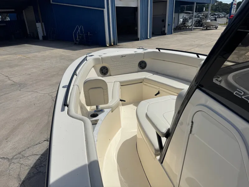 Slide: The Image of The image shows the deck of a 2027 Scout 240 XSF boat with seating and speakers. - 15