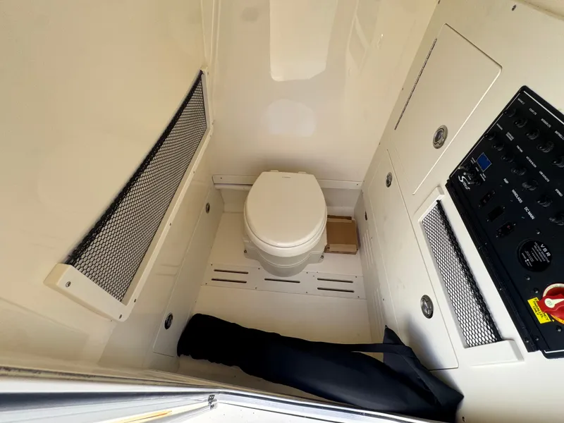 Slide: The Image of Interior of a Scout 240 XSF featuring a toilet and control panel. - 14