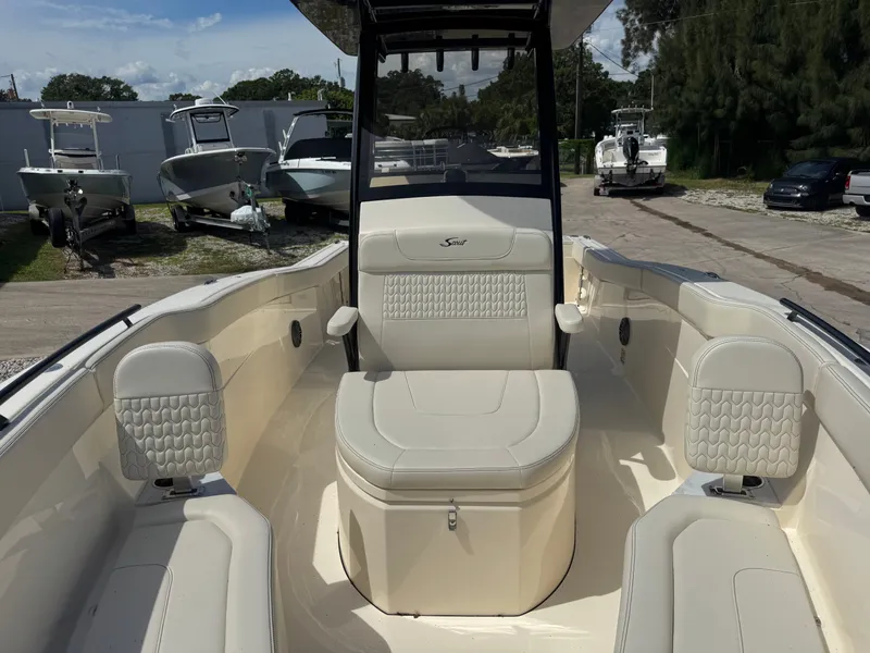 Slide: The Image of 2027 Scout 240 XSF with beige upholstery and modern design in an outdoor setting. - 16