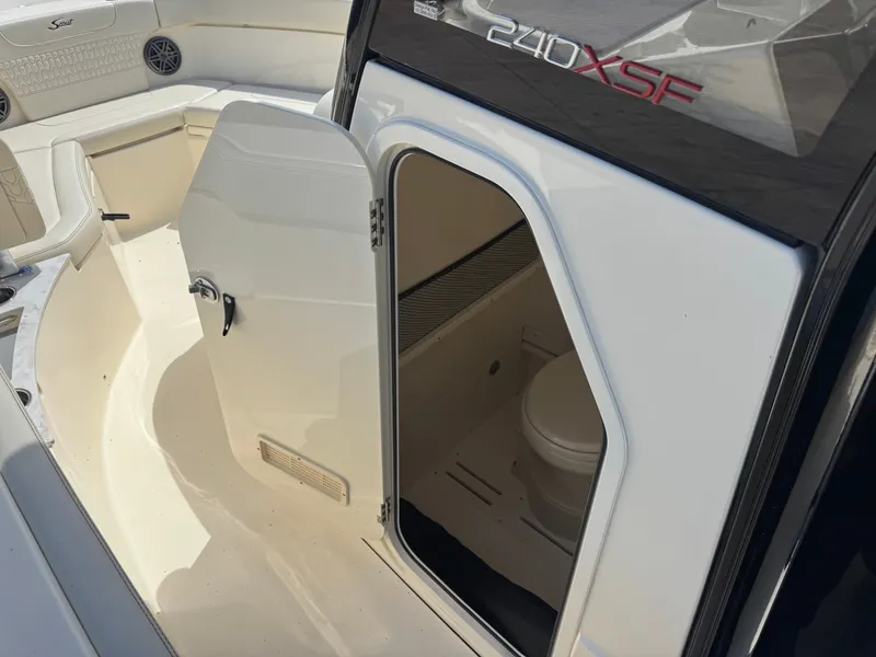 Slide: The Image of The 2027 Scout 240 XSF features an open cabin door revealing a toilet inside. - 13