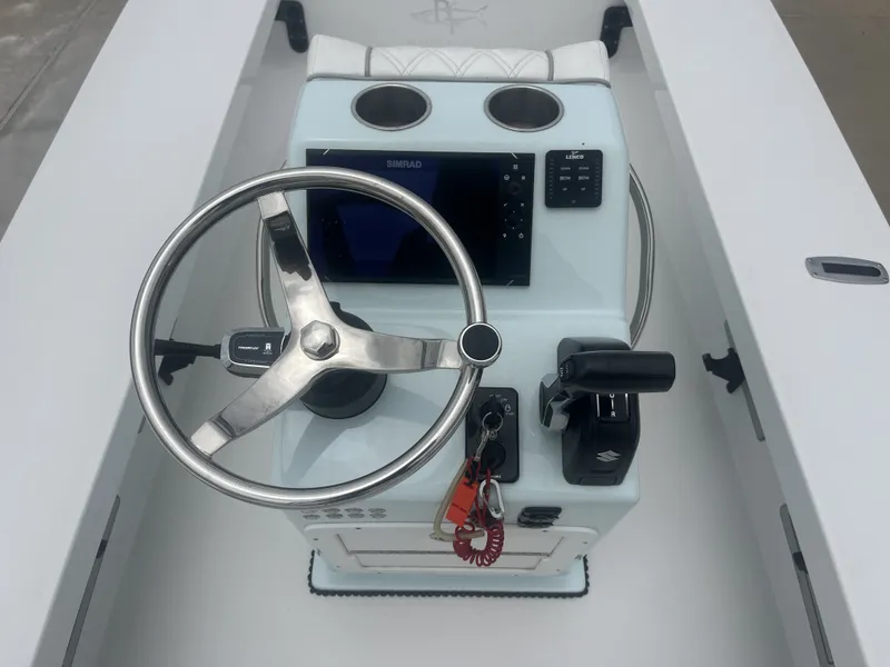 Slide: The Image of 2024 Beavertail Strike 17 helm with steering wheel and electronics. - 23