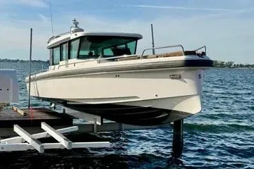 The Image of 2018 Axopar 37 XC CROSS CABIN boat on lift over water. - 0