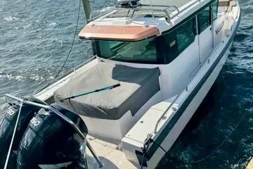 Slide: The Image of 2018 Axopar 37 XC CROSS CABIN boat on water with twin outboard engines. - 5