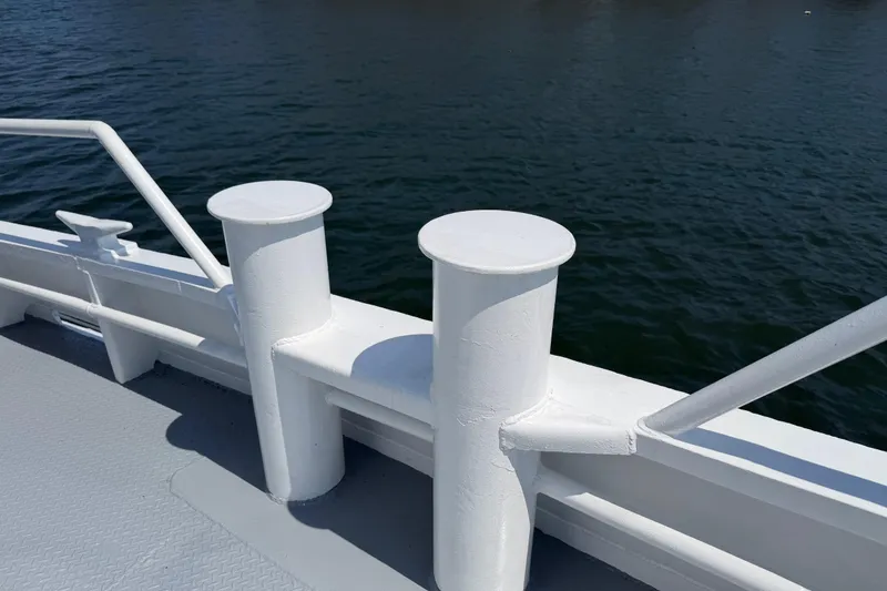 Slide: The Image of White deck bollards on 1954 American 70 Tugboat, overlooking calm water. - 12