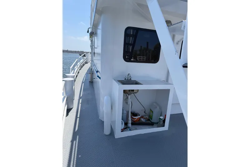 Slide: The Image of 1954 American 70 Tugboat deck with outdoor sink and ocean view. - 14