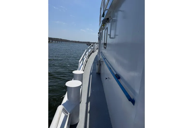 Slide: The Image of Side view of a 1954 American 70 Tugboat on calm water. - 15
