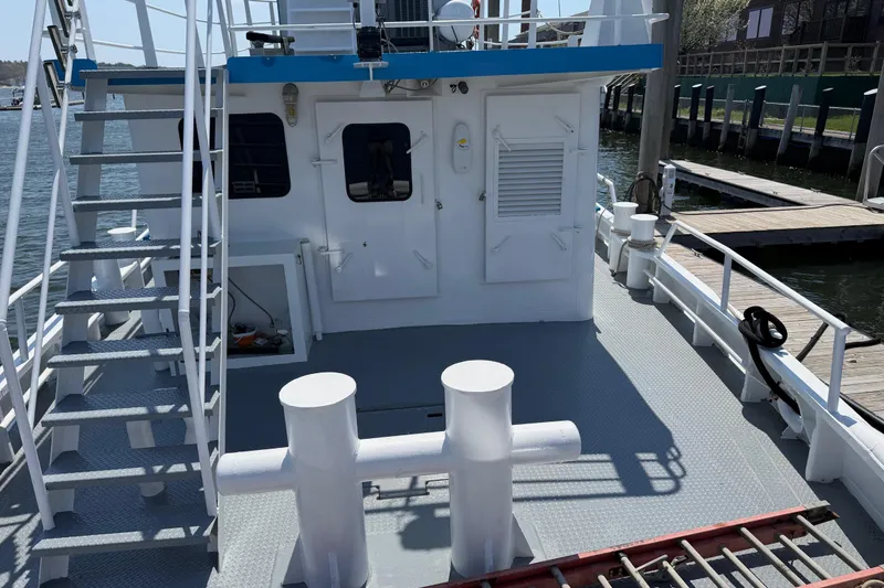 Slide: The Image of 1954 American 70 Tugboat deck with stairs and dockside view. - 17