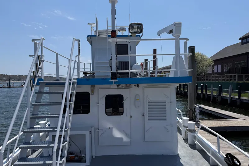 Slide: The Image of 1954 American 70 Tugboat docked, featuring upper deck and nautical equipment. - 18