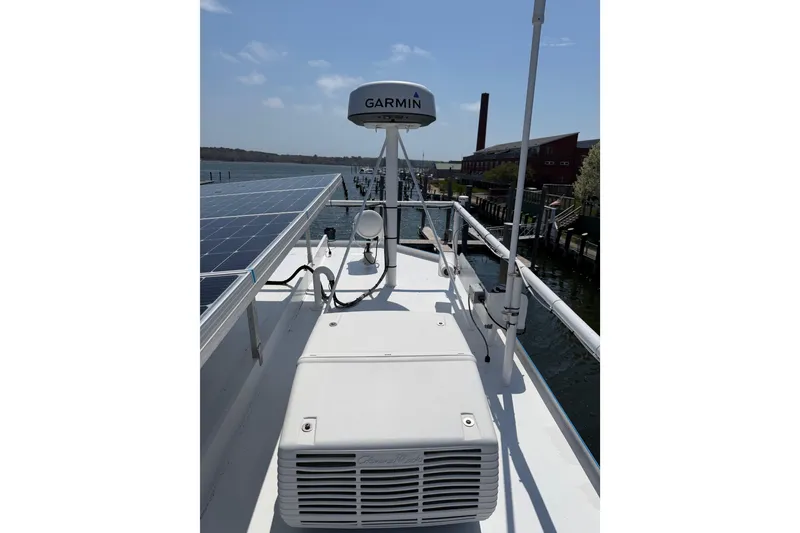 Slide: The Image of Rooftop view of 1954 American 70 Tug with solar panels and Garmin equipment. - 26