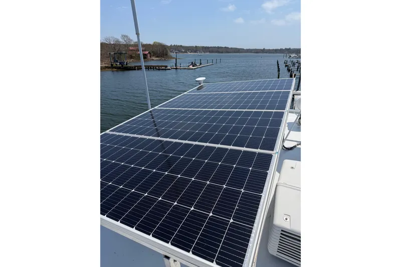Slide: The Image of Solar panels on a 1954 American 70 Tug boat by the water. - 28