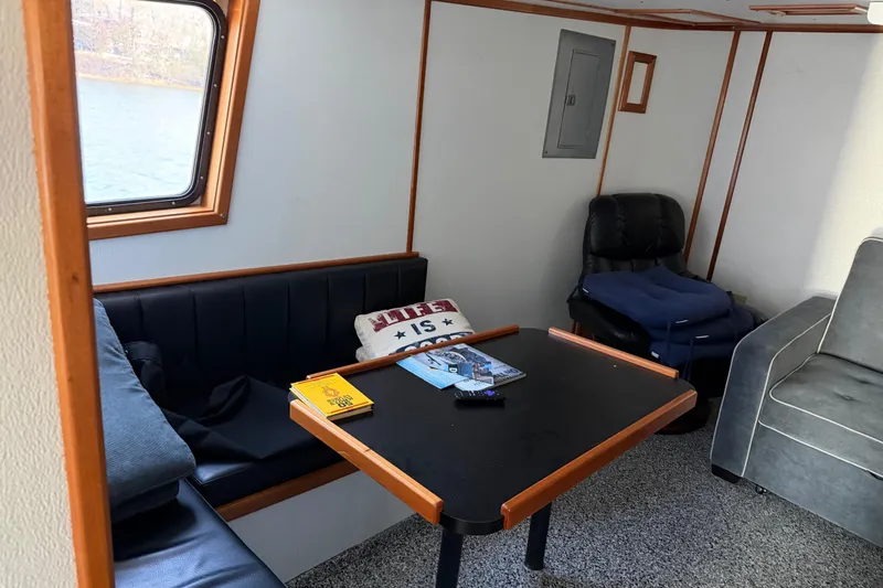 Slide: The Image of Cozy interior of a 1954 American 70 Tug boat with seating and table. - 34