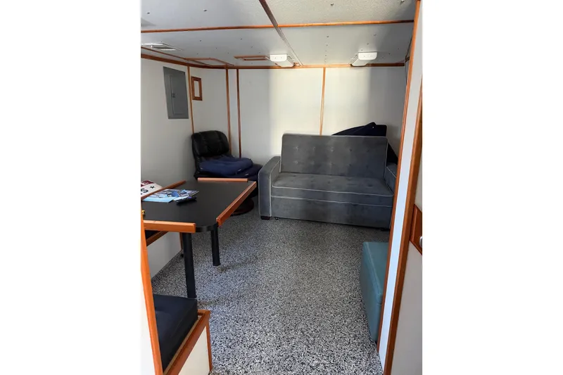 Slide: The Image of Interior of a 1954 American 70 Tug with seating and table. - 35