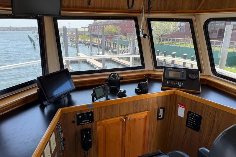 Slide: The Image of 1954 American 70 Tugboat interior with navigation equipment and waterfront view. - 36