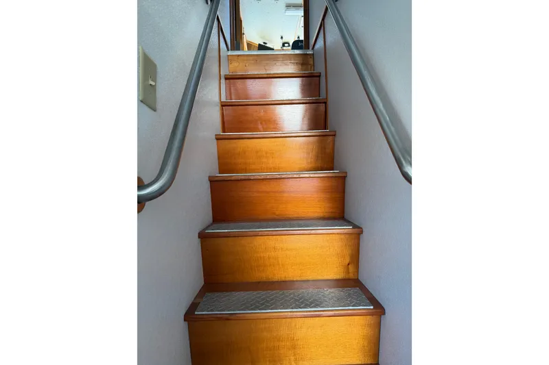 Slide: The Image of Wooden stairs with metal treads inside a 1954 American 70 Tug boat. - 39