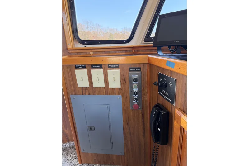Slide: The Image of 1954 American 70 Tugboat control panel with switches, anchor winch, and communication device. - 46