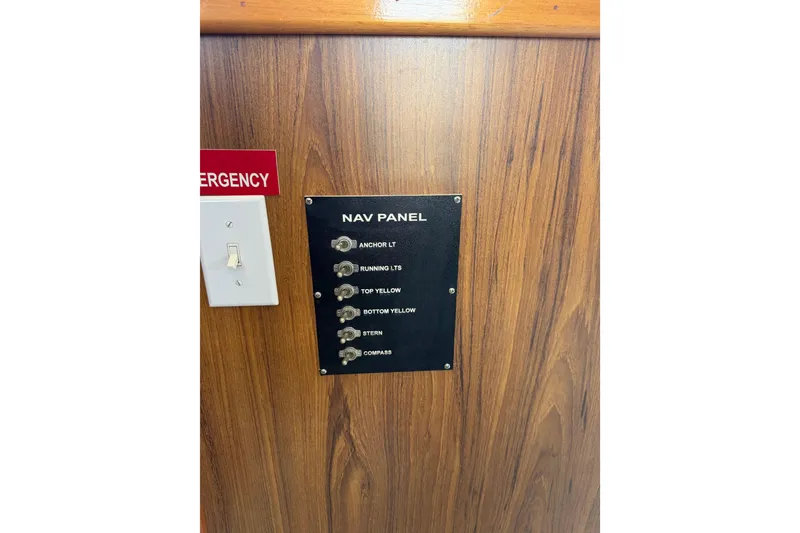 Slide: The Image of Navigation panel on a 1954 American 70 Tug, featuring various light switches. - 47