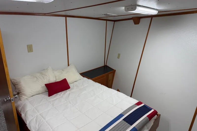 Slide: The Image of Cozy bedroom with white bedding and colorful throw on a 1954 American 70 Tug. - 50