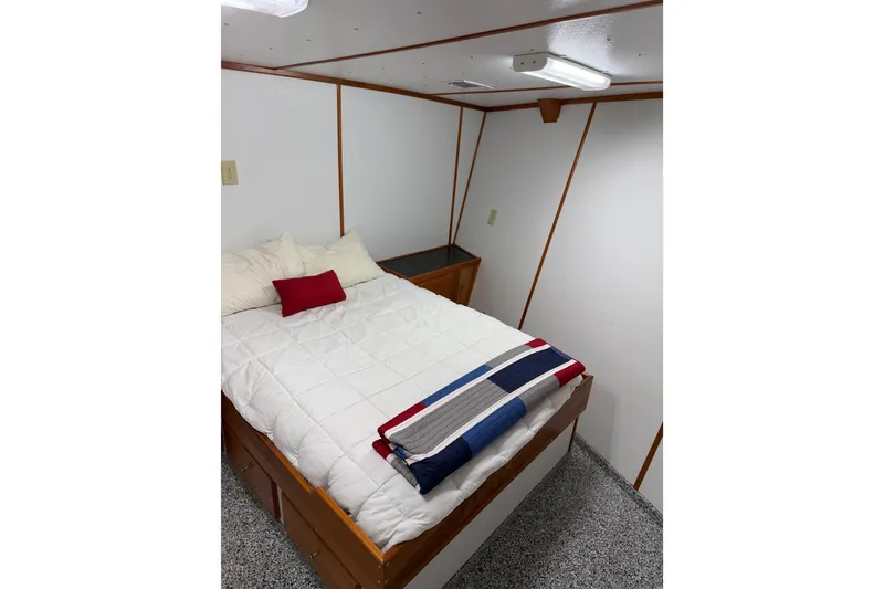 Slide: The Image of Cozy bedroom with white bedding and colorful throw on a 1954 American 70 Tug boat. - 51