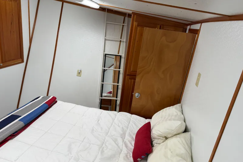 Slide: The Image of Cozy bedroom interior in a 1954 American 70 Tug boat with ladder and wooden accents. - 52