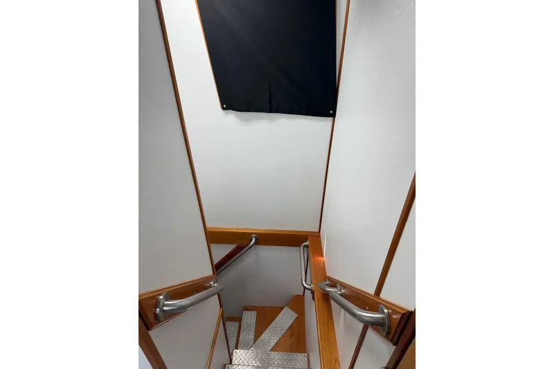 Slide: The Image of Staircase with wooden handrails inside a 1954 American 70 Tug boat. - 53