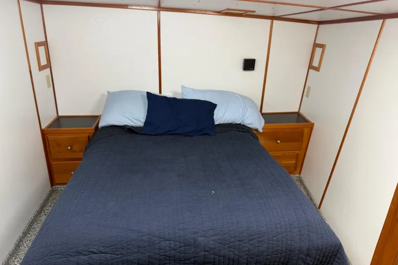 Slide: The Image of Cozy bedroom with blue bedding in a 1954 American 70 Tug boat. - 54