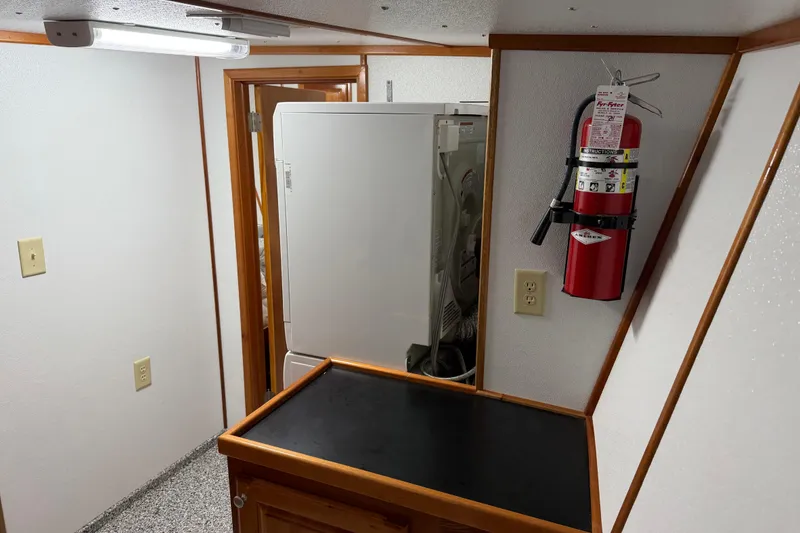 Slide: The Image of Interior of a 1954 American 70 Tug with fire extinguisher and laundry area. - 55