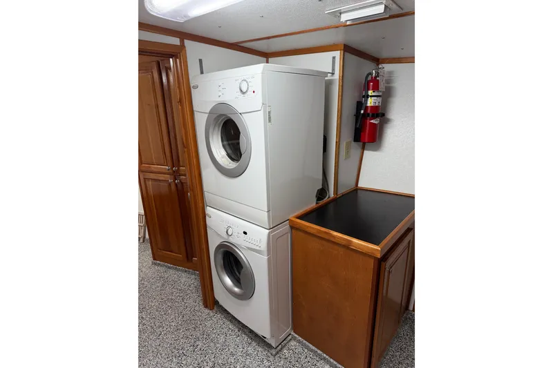 Slide: The Image of Stacked washer and dryer in a 1954 American 70 Tug interior. - 58