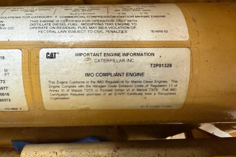 Slide: The Image of Caterpillar engine compliance label on a 1954 American 70 Tug, detailing IMO regulations. - 61