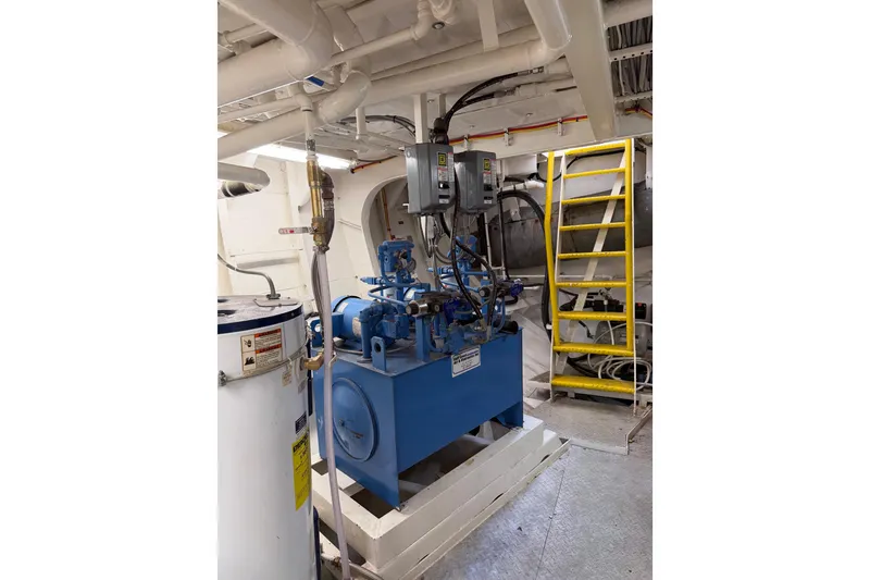 Slide: The Image of Engine room of a 1954 American 70 Tugboat with machinery and yellow ladder. - 63