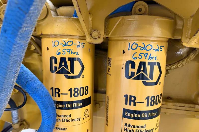 Slide: The Image of CAT engine oil filters with handwritten maintenance date and hours, American 70 Tug, 1954 model. - 64
