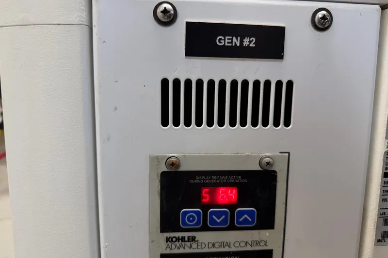 Slide: The Image of Control panel of a Kohler generator, labeled "GEN #2," displaying "56.4". - 72