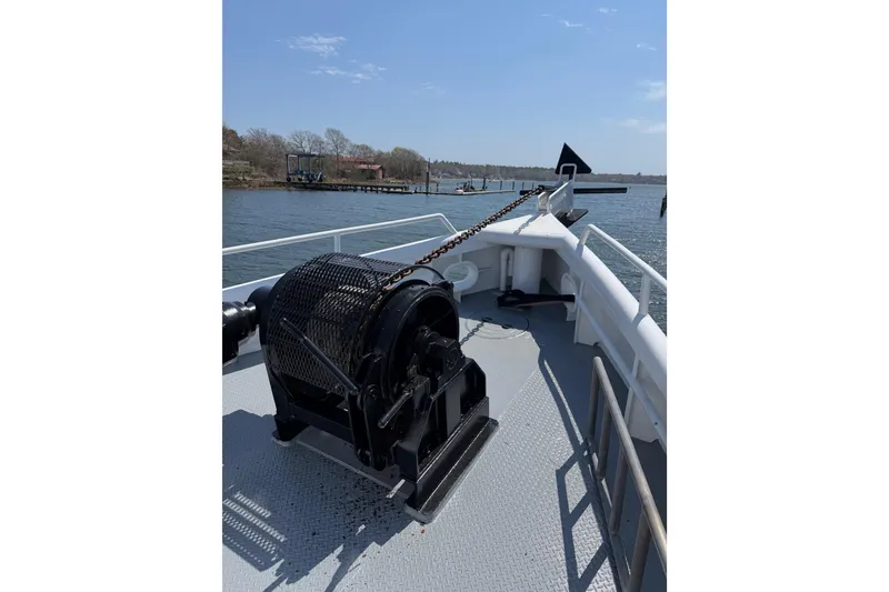 Slide: The Image of Bow of 1954 American 70 Tugboat with anchor winch on calm water. - 8