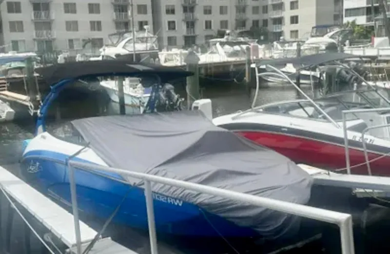 Slide: The Image of 2019 Yamaha Boats 242X E-Series covered at marina dock. - 17