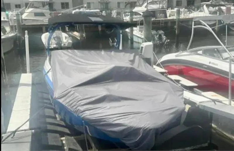 Slide: The Image of 2019 Yamaha Boats 242X E-Series covered at marina dock. - 19