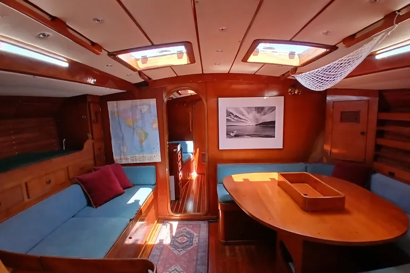 Slide: The Image of Interior of 1981 SKYE 51 yacht with wooden furnishings and cozy seating area. - 10