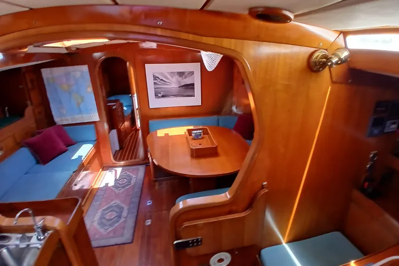 Slide: The Image of Interior of 1981 SKYE 51 yacht with wooden furnishings and cozy seating area. - 11