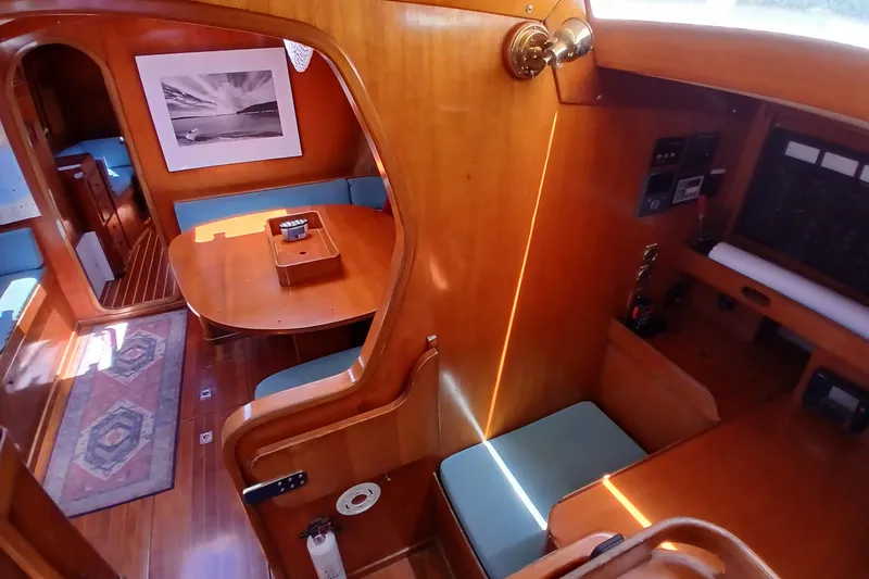 Slide: The Image of Interior of 1981 SKYE 51 yacht with wooden furnishings and cozy seating area. - 12