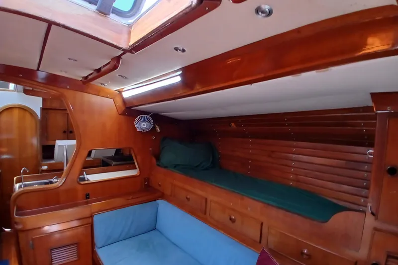 Slide: The Image of Interior of 1981 SKYE 51 yacht with wooden finish and cozy seating area. - 15